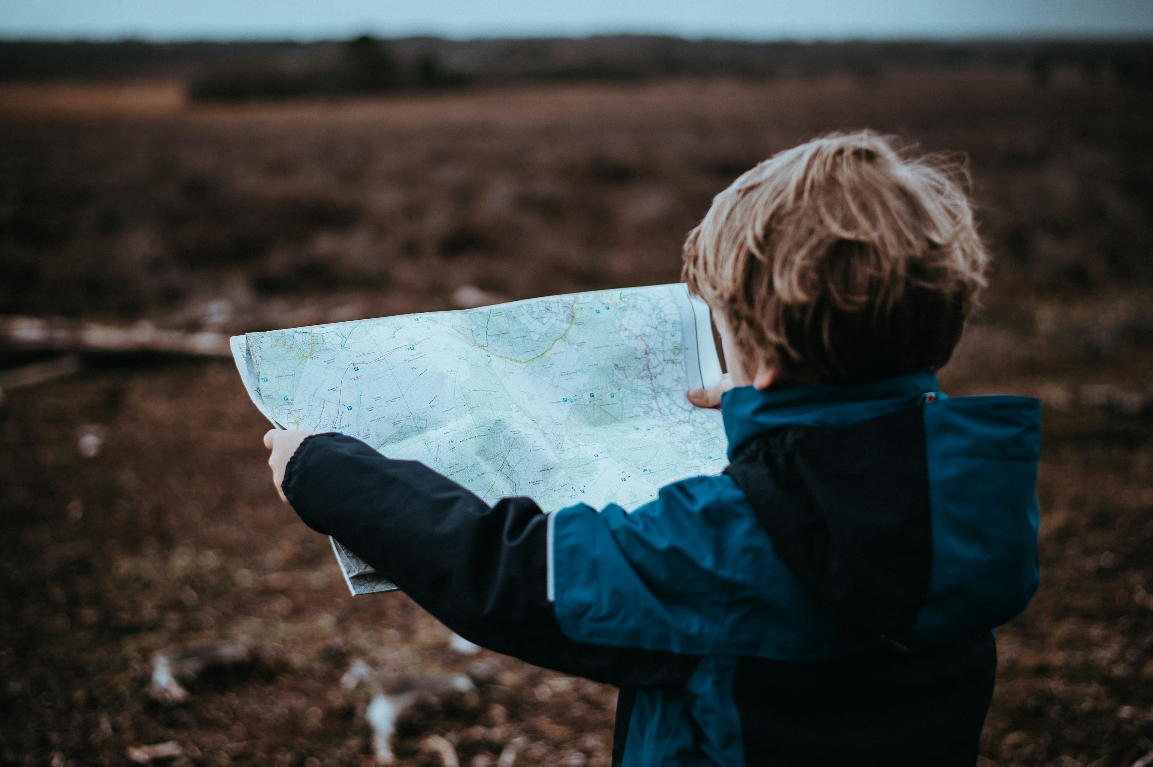 A child studying a large map