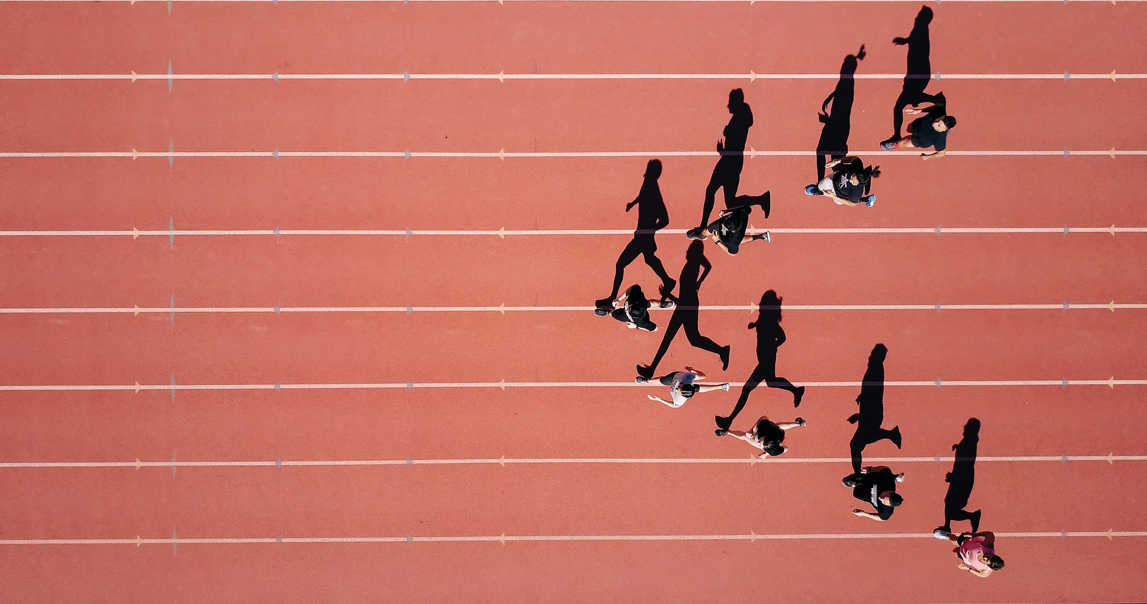 A group of people running in a stadium