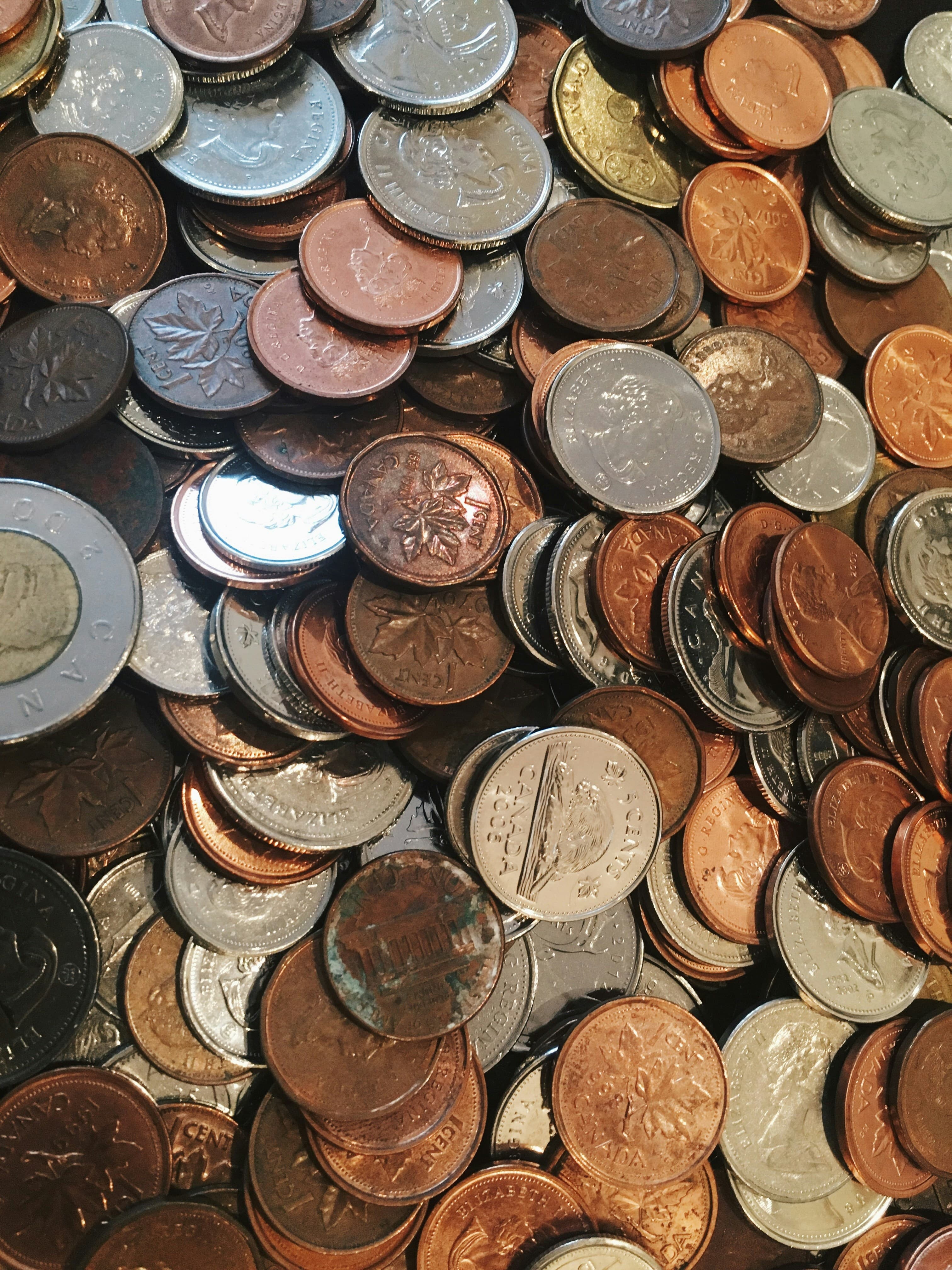 An assortment of coins spread on a surface