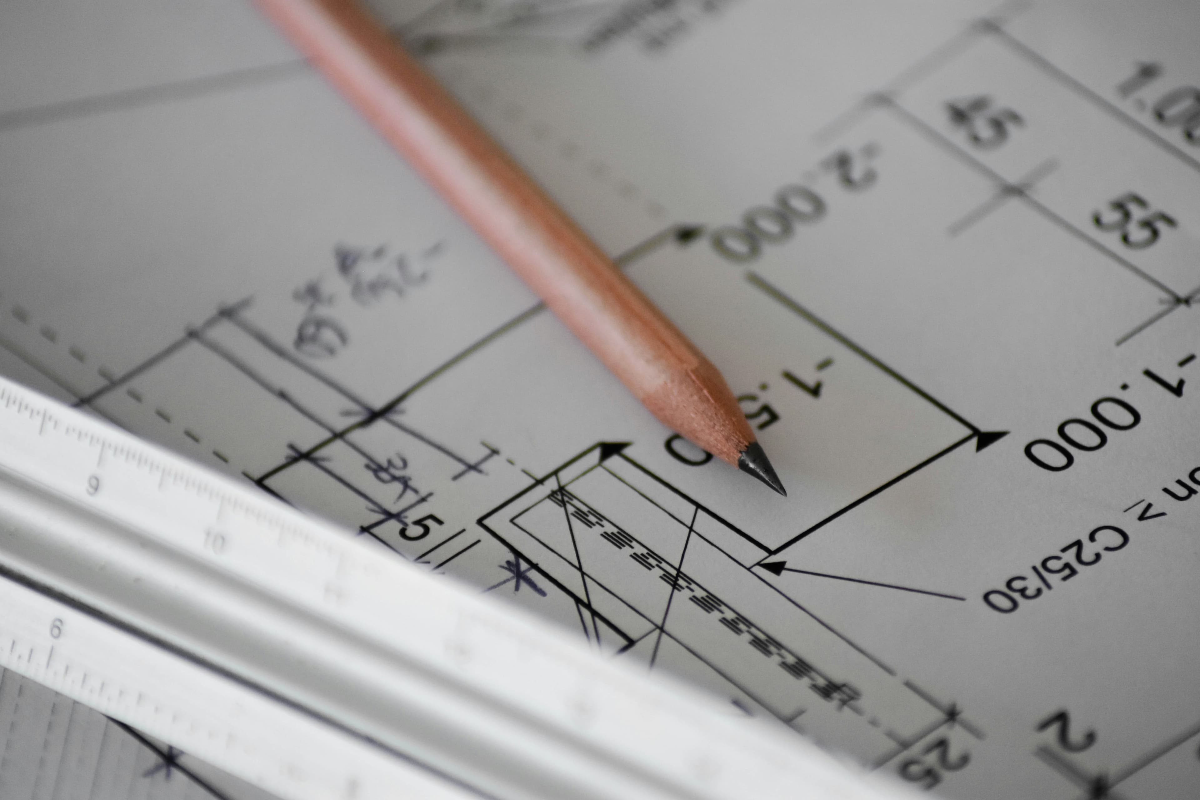 A pencil resting on a sheet of white drawing paper
