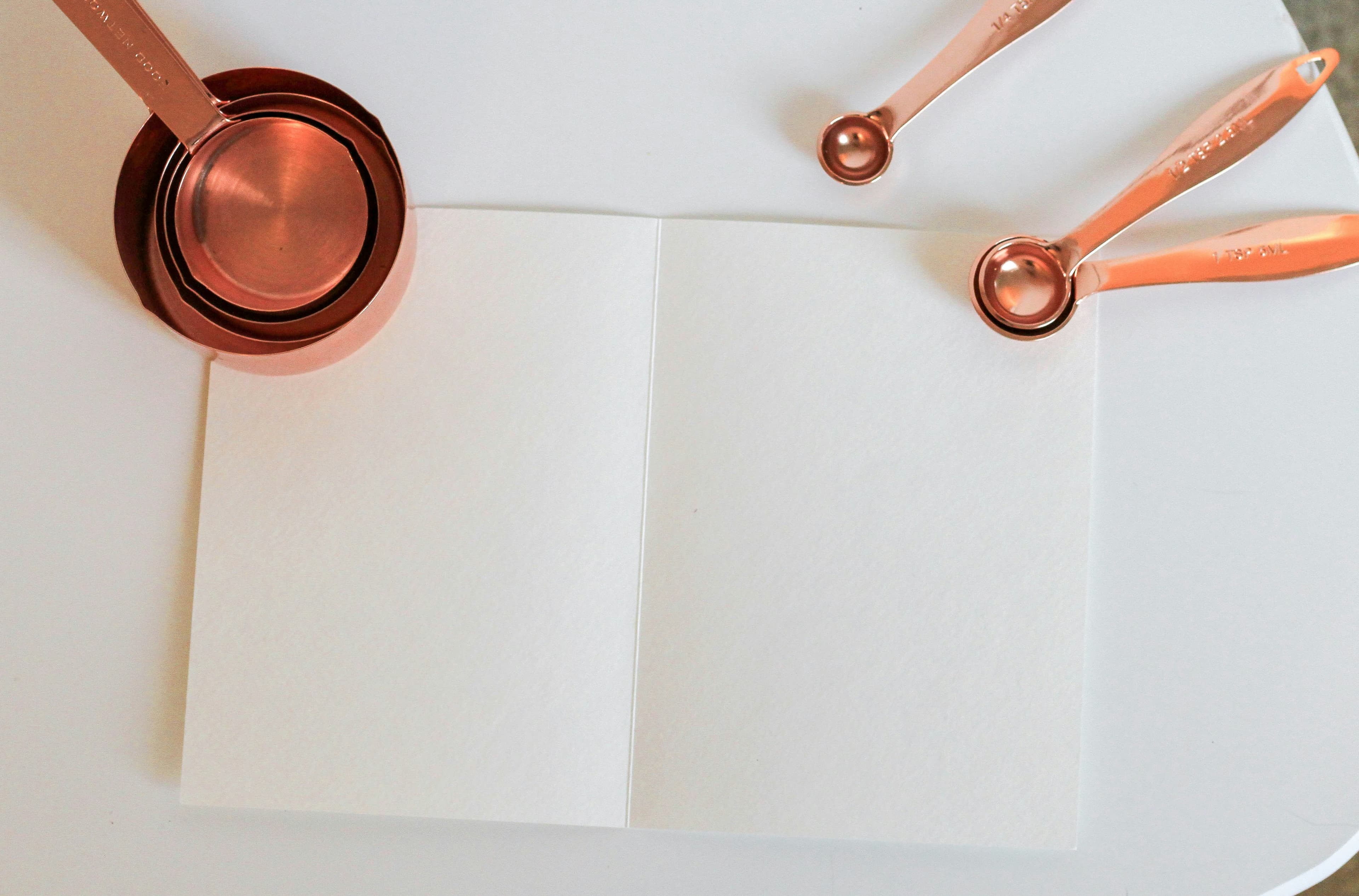 A measuring cup sitting on white paper