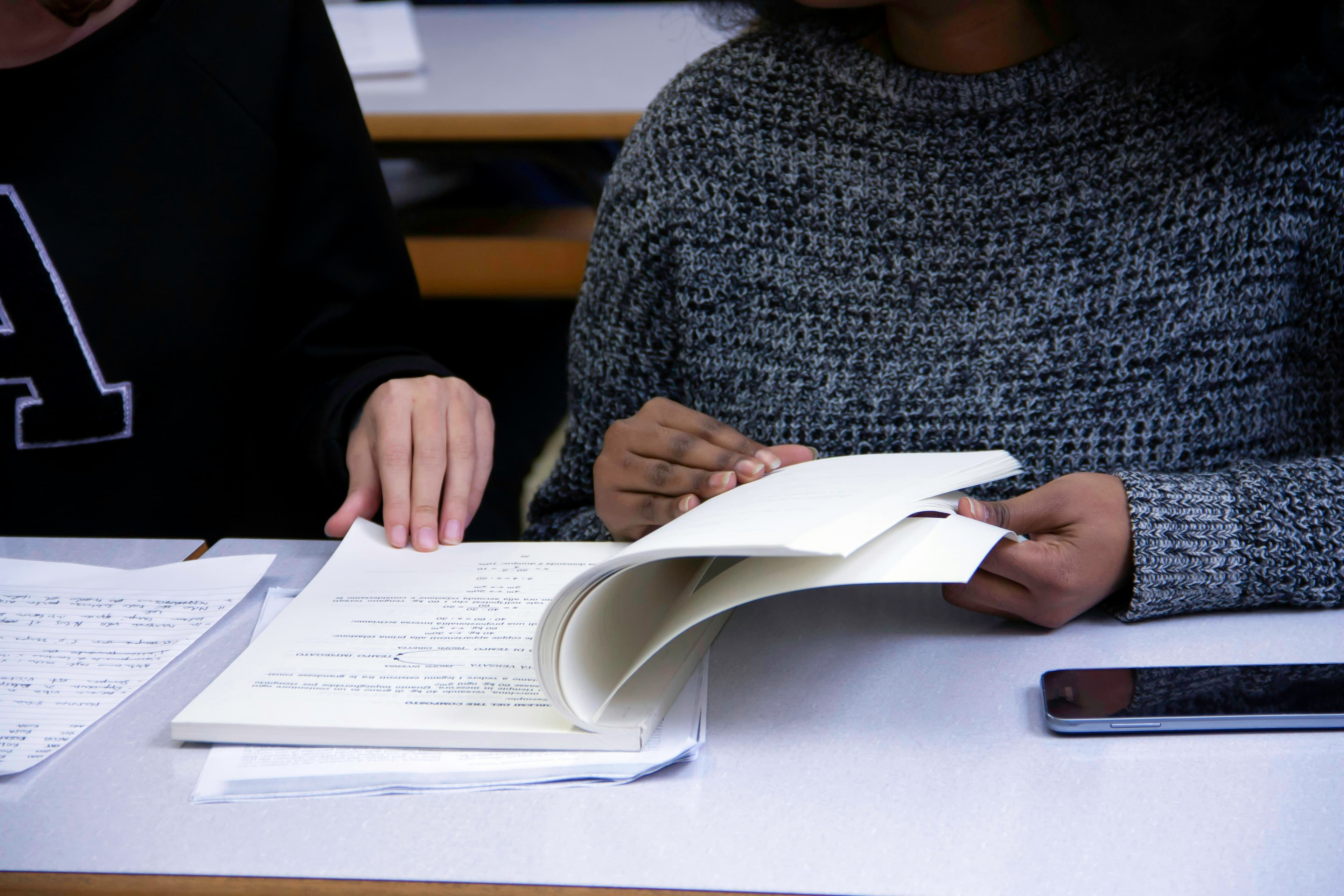 A student flipping through the pages of a book