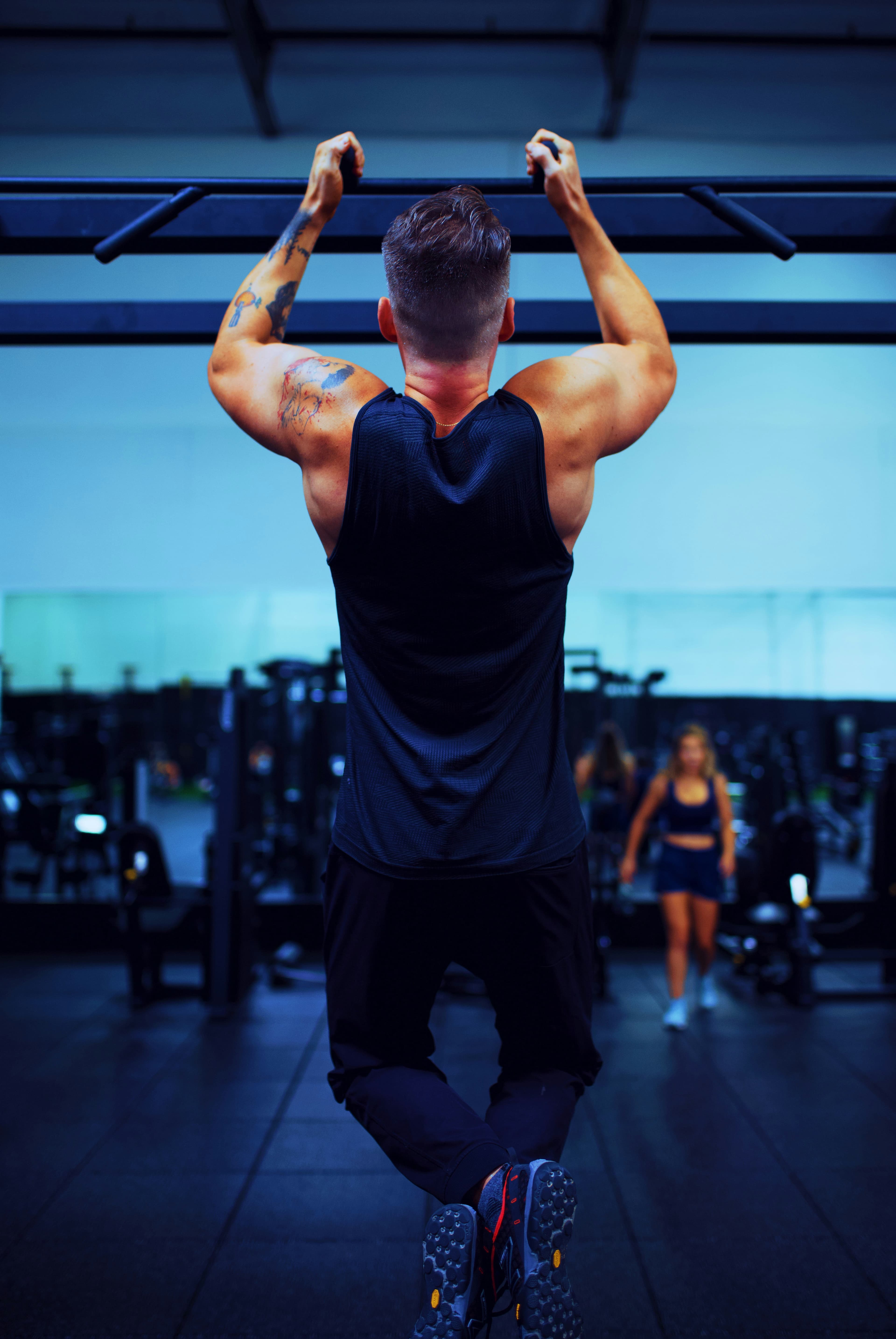A man in a black t-shirt doing a floor exercise
