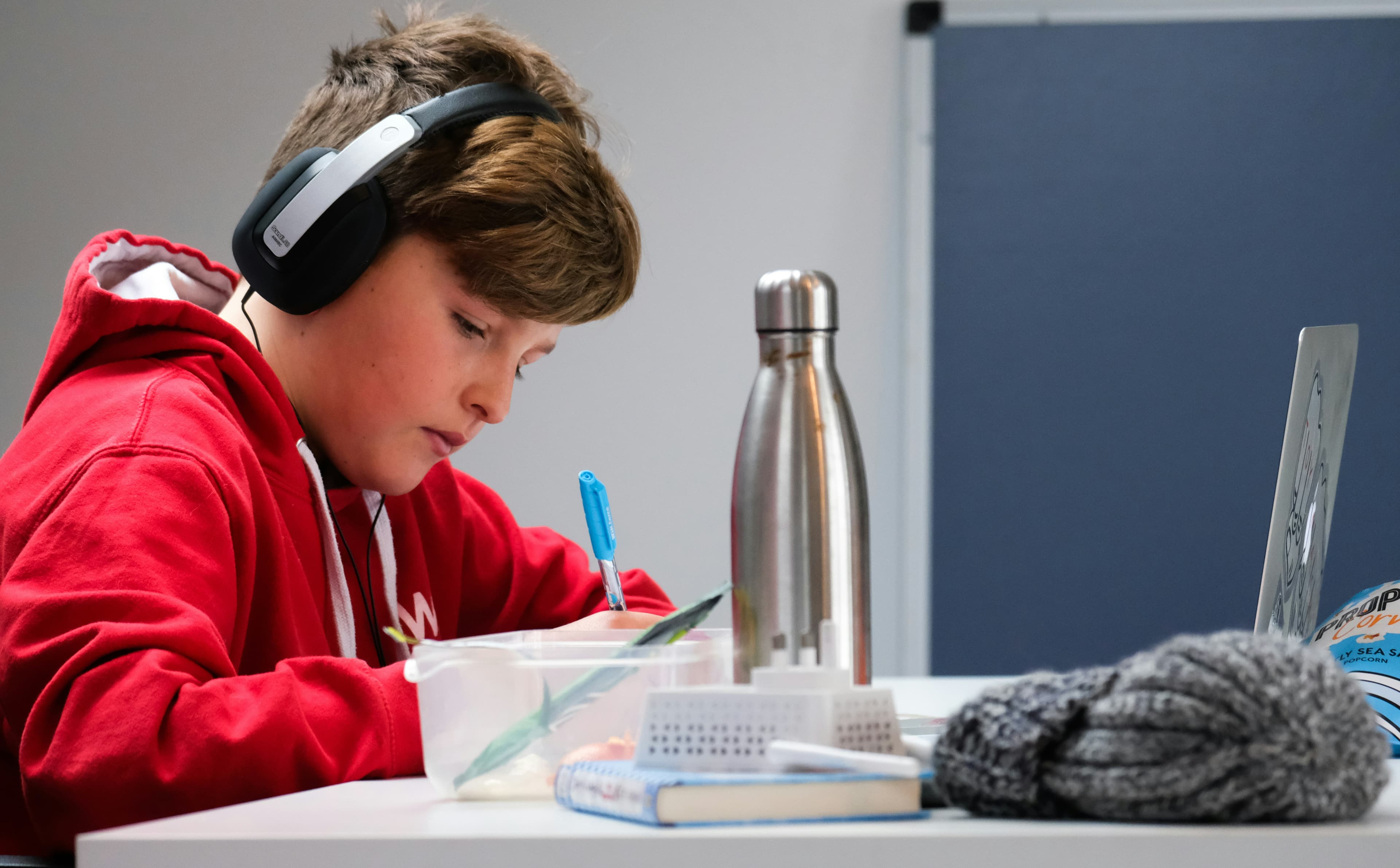 A student wearing headphones while studying