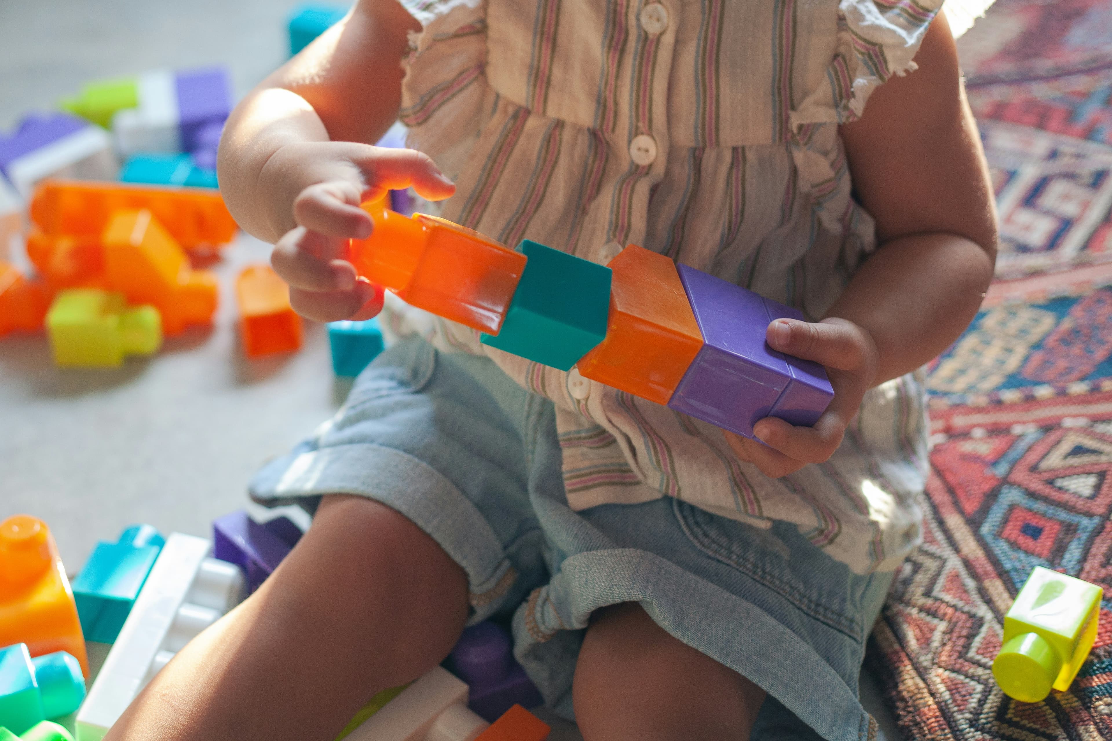 A young girl holding a plastic toy