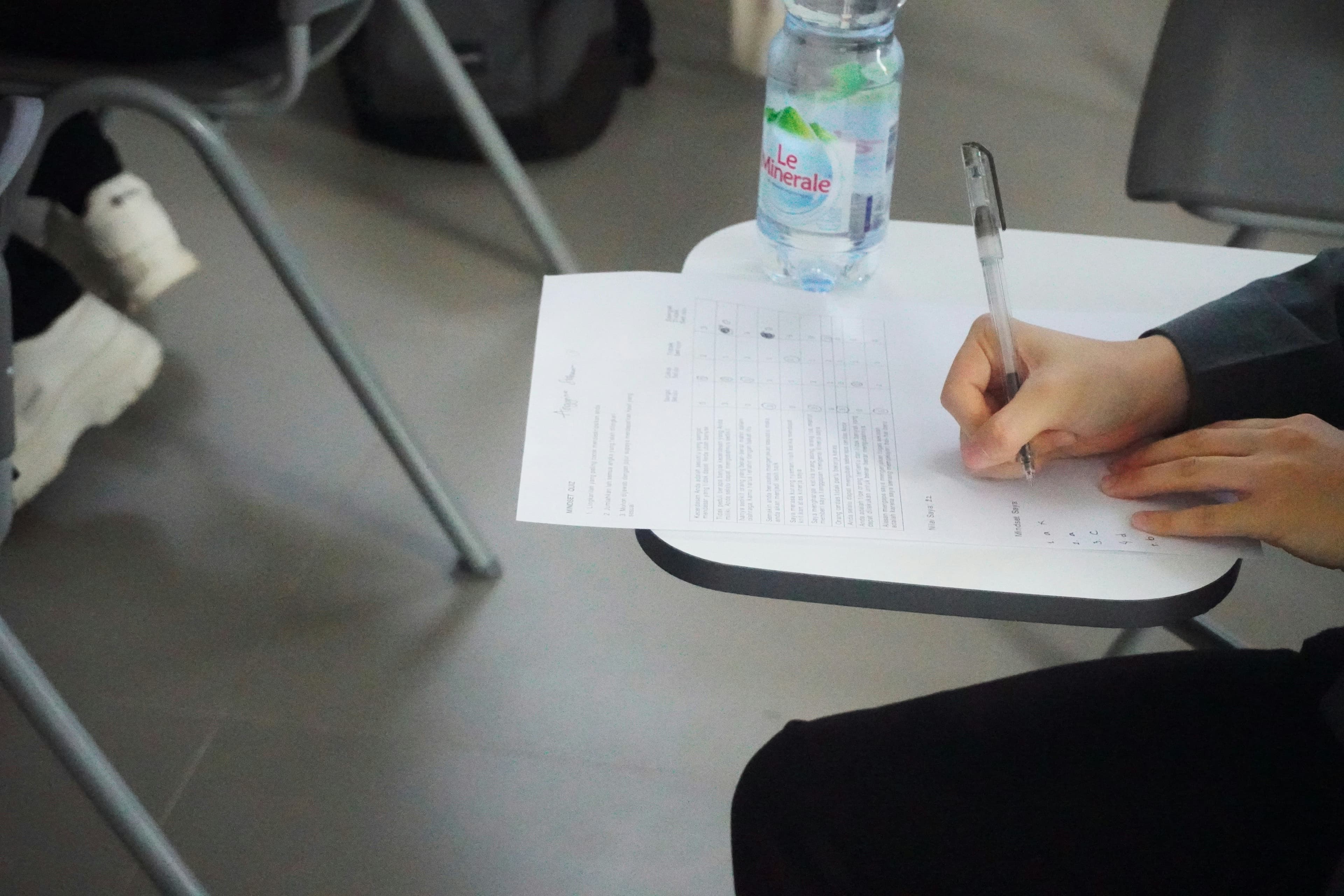A person writing on a piece of paper