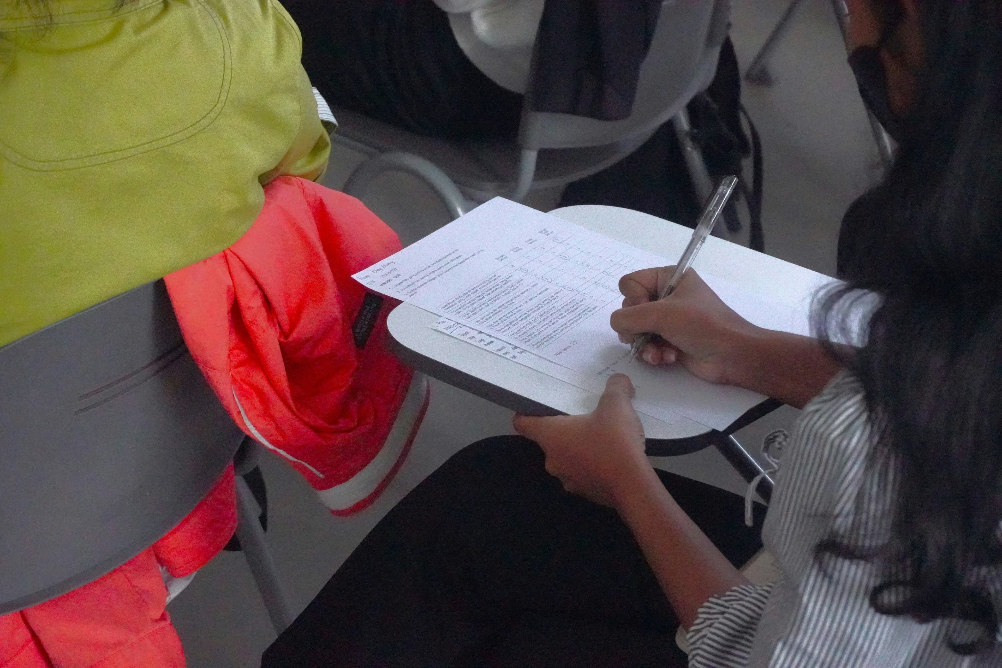 A person writing on a piece of paper