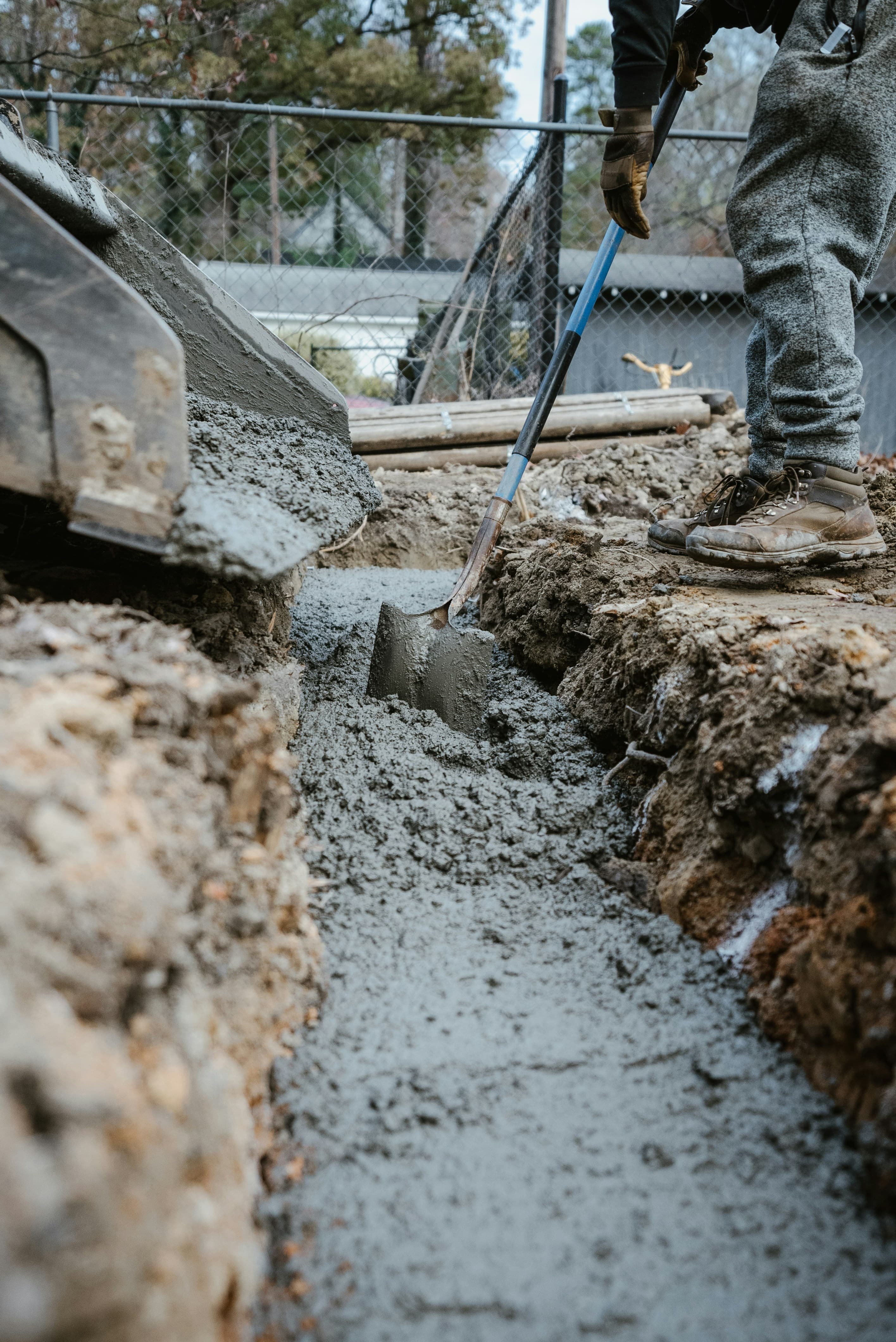 A person digging in dirt with a shovel