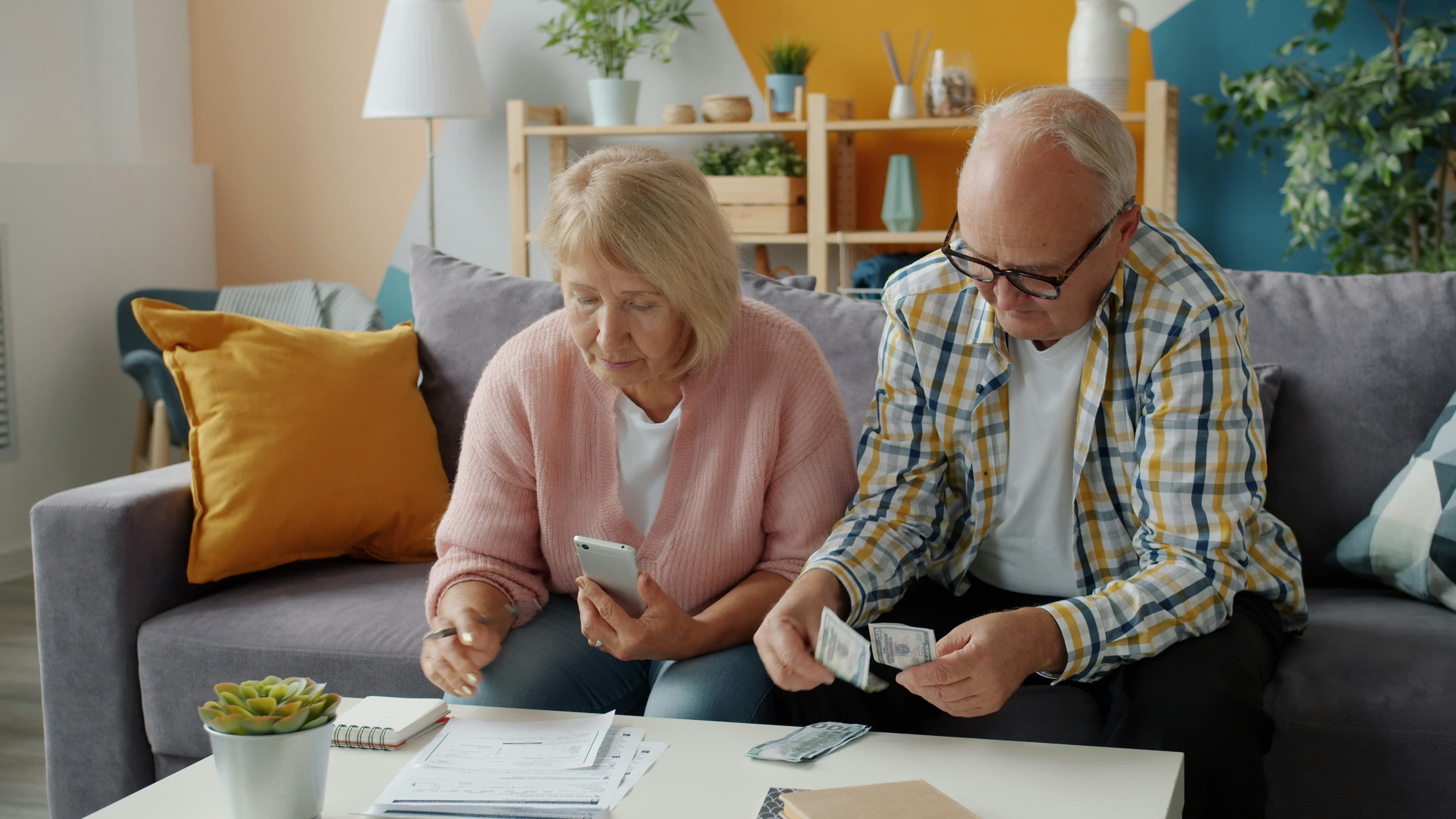 An elderly couple managing their finances at home